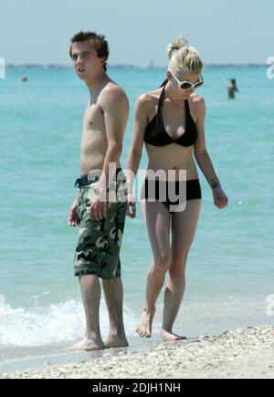 Exclusive!! Love blooms for Frankie Muniz and fiancee Jamie Gandy on Miami Beach. The couple collected sea shells together and kissed in the surf during the filming of Frankies new movie 'My Sexiest Year'. 5/5/06 Stock Photo