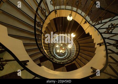 Old vintage Spiral circle Staircase decoration interior, high lighthouse stairs. A spiral staircase spiraling down about five floors. The winding conc Stock Photo