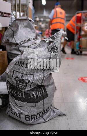 Parcels and letters in Royal Mail postal posting sack, mailing post parcel bag. Royal Mail post office inside Stock Photo