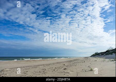 Baltic sea coast, small waves on the sea, ships on the sea horizon Stock Photo