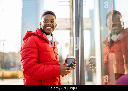 Young man window shopping on city street Stock Photo