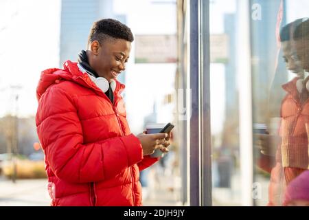 Young man window shopping on city street Stock Photo