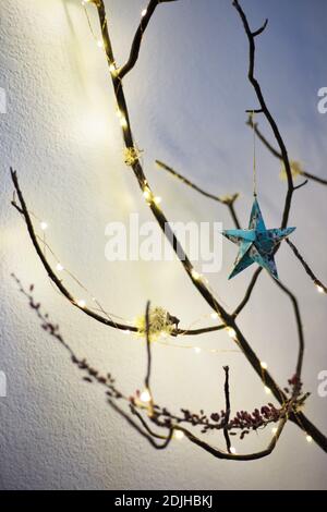 An alternative Christmas tree made from a found moss covered branch. Stock Photo