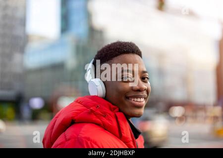 Young man wearing headphones and listening to music in the city Stock Photo