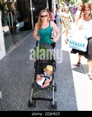 Actress Melissa Joan Hart, best known as the TV star of 'Sabrina the Teenage Witch,' went shopping with baby son at Kitson and Kitson Kids in LA with a friend. After shopping they retired to the News Cafe to escape the heat. 6/16/06 Stock Photo