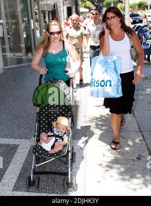 Actress Melissa Joan Hart, best known as the TV star of 'Sabrina the Teenage Witch,' went shopping with baby son at Kitson and Kitson Kids in LA with a friend. After shopping they retired to the News Cafe to escape the heat. 6/16/06 Stock Photo