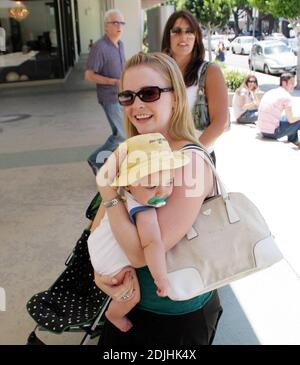 Actress Melissa Joan Hart, best known as the TV star of 'Sabrina the Teenage Witch,' went shopping with baby son at Kitson and Kitson Kids in LA with a friend. After shopping they retired to the News Cafe to escape the heat. 6/16/06 Stock Photo