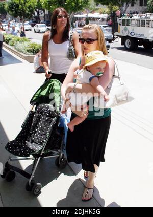 Actress Melissa Joan Hart, best known as the TV star of 'Sabrina the Teenage Witch,' went shopping with baby son at Kitson and Kitson Kids in LA with a friend. After shopping they retired to the News Cafe to escape the heat. 6/16/06 Stock Photo