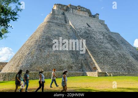 Tourists wearing face masks visiting Uxmal Mayan Ruins in Yucatan Mexico during the Covid-19 Pandemic, December 2020. Stock Photo