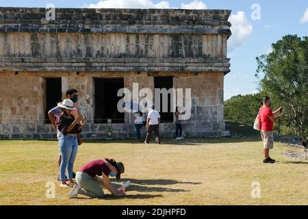 Tourists wearing face masks visiting Uxmal Mayan Ruins in Yucatan Mexico during the Covid-19 Pandemic, December 2020. Stock Photo