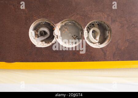 Three holes in the wall for new sockets Stock Photo