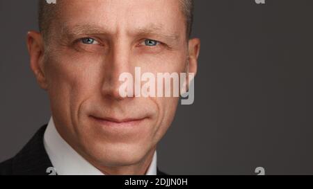 Close up portrait shot of an attractive and successful middle aged man male. Middle-aged man looking at camera with a serious expression in a close up Stock Photo