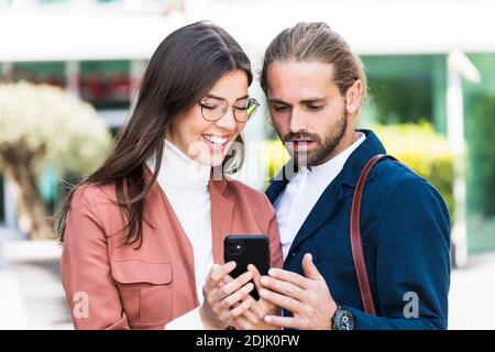 young business people using smartphone in the city Stock Photo