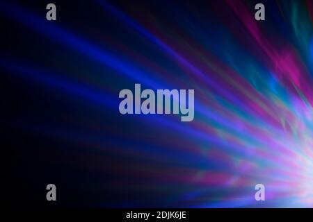 Colorful rays of light or light beams at dark. Abstract high resolution background. Stock Photo
