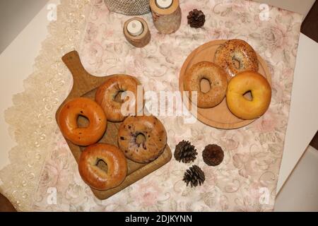 Stacked Freshly Baked Bread Bagels on table Stock Photo