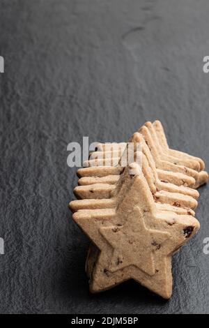 Christmas  cookies with cranberry on black stone background Stock Photo