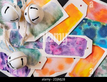 Homemade gift tags made out of watercolor paper and painted with watercolor paint in abstract free flowing designs. Stock Photo