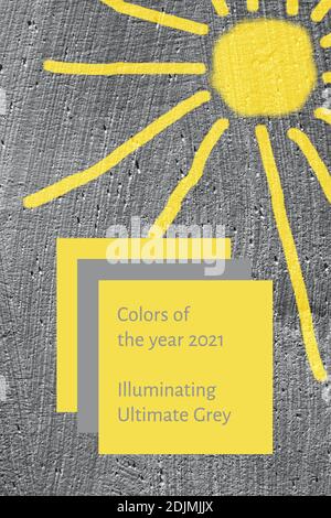 Background grey smooth concrete wall with painted yellow sun. Colors of year 2021. Vertical. Stock Photo