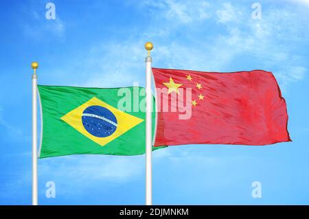 Brazil and China two flags on flagpoles and blue cloudy sky Stock Photo