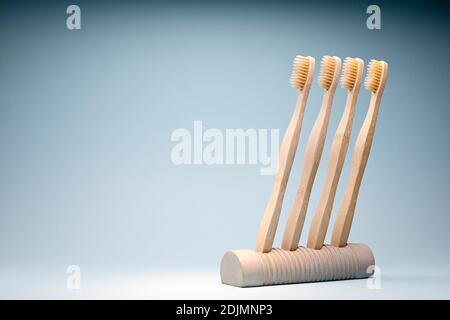 Eco-friendly wooden toothbrushes in a concrete stand Stock Photo