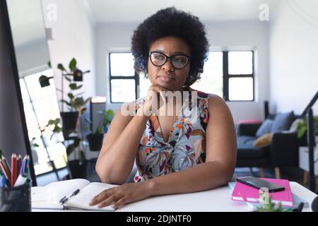 African american female vlogger recording a video rubbing her chin Stock Photo