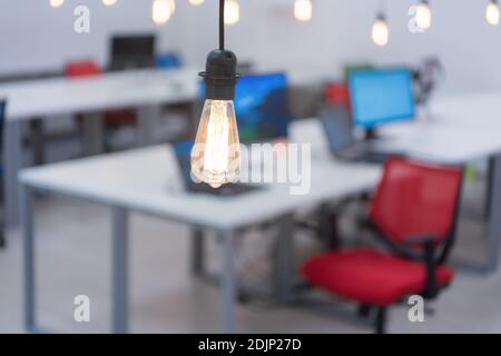Empty no people open space creative co-working center workplace desks with computer monitors modern office interior Stock Photo