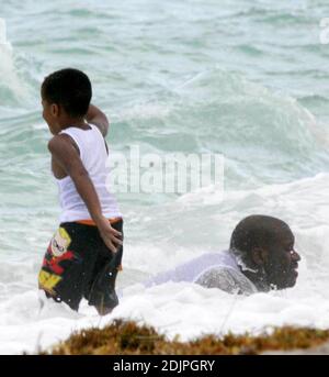 Exclusive!! Shaquille O'Neal spends a day on Miami Beach with wife Shaunie and family. The NBA superstar frolicked with kis kids in the surf and seemed to be having a whale of a time.  Professionally, O'Neal has not only been playing ball, but also the real estate market.  Possessing an impressive real estate portfolio since his rookie days, he recently announced a new firm, The O'Neal Group, which will be involved in a $1 billion project to build 1,100 residential units in a sprawling downtown Miami complex. 9/17/06 Stock Photo