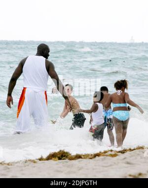 Exclusive!! Shaquille O'Neal spends a day on Miami Beach with wife Shaunie and family. The NBA superstar frolicked with kis kids in the surf and seemed to be having a whale of a time.  Professionally, O'Neal has not only been playing ball, but also the real estate market.  Possessing an impressive real estate portfolio since his rookie days, he recently announced a new firm, The O'Neal Group, which will be involved in a $1 billion project to build 1,100 residential units in a sprawling downtown Miami complex. 9/17/06 Stock Photo