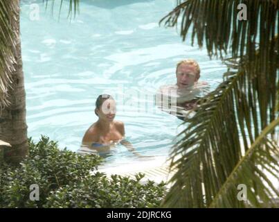 Boris Becker takes a refreshing dip in the pool with girlfriend with Sharlely Kerssenberg.  Miami Beach Fl. 10/10/06 Stock Photo