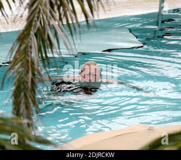 Boris Becker takes a refreshing dip in the pool with girlfriend with Sharlely Kerssenberg.  Miami Beach Fl. 10/10/06 Stock Photo