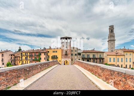 Verona, Province of Verona, Veneto, Italy. The Ponte di Pietra bridge and the bell tower of the Cathedral of Verona Stock Photo