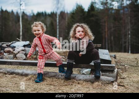 Brother and sister hugging in forest Stock Photo - Alamy