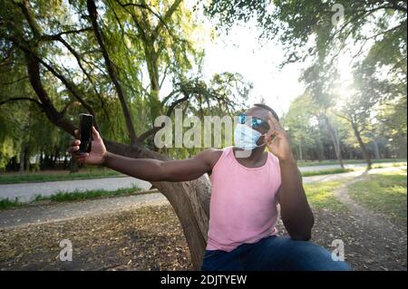 A young black man with a mask in the covid-19 pandemic season. Stock Photo