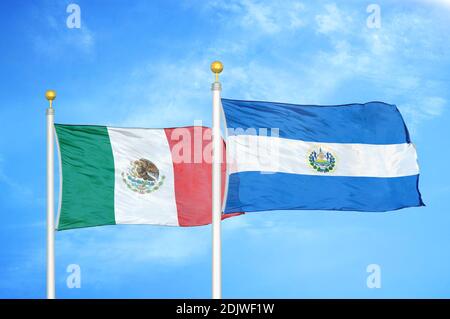 Mexico and El Salvador two flags on flagpoles and blue cloudy sky Stock Photo