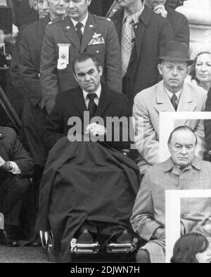 Former Democratic candidate for the President of the United States, Governor George C. Wallace (Democrat of Alabama), in wheelchair, listens as US President Richard M. Nixon delivers his Inaugural speech at the US Capitol in Washington, DC on January 20, 1973. Wallace was paralyzed after suffering a gunshot wound while campaigning for the nomination in Maryland. At lower right is entertainer Bob Hope, a big Nixon supporter during the campaign. Photo by Arnie Sachs/CNP/ABACAPRESS.COM Stock Photo