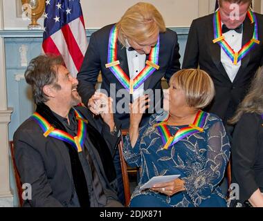 Al Pacino, left, one of the five recipients of the 39th Annual Kennedy Center Honors, gospel and blues singer Mavis Staples, right, and Joe Walsh of the rock band 'The Eagles,' center, congratulate one another as they prepare to pose for a group photo following a dinner hosted by United States Secretary of State John F. Kerry in their honor at the U.S. Department of State in Washington, D.C. on Saturday, December 3, 2016. The 2016 honorees are: Argentine pianist Martha Argerich; rock band the Eagles; screen and stage actor Al Pacino; gospel and blues singer Mavis Staples; and musician James Ta Stock Photo