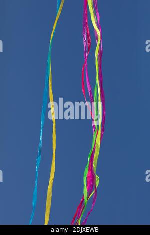 Rainbows of abstract moving lines, in vivid colors, formed by wrinkled fabrics that float lightly on a plain-colored background. Stock Photo