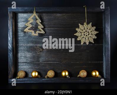Golden Christmas decoration elements on wooden background Stock Photo