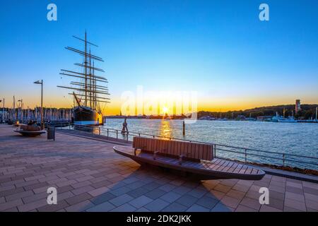 Germany, Schleswig-Holstein, the Baltic resort of Travemünde, Evening mood on the new promenade on the Priwall between the Passat and the small Priwall ferry, View of the four-masted steel barque Passat in the sunset, Stock Photo