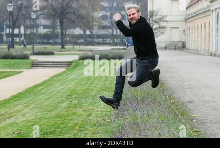 Berlin, Germany. 03rd Dec, 2020. Actor Martin Luding (49) jumps over a flower bed during a walk at Charlottenburg Palace. The native Berliner can now be seen as Jens Reichard in the ARD telenovela 'Rote Rosen' from the 18th season. He has already acted in numerous television films and stage productions such as 'Caveman'. His personal interests lie in crafts and sports activities, such as hiking and cycling in the mountains. His love for Africa led him on a safari of several weeks through the Serengeti and even to the Kilimanjaro. Credit: Jens Kalaene/dpa-Zentralbild/ZB/dpa/Alamy Live News Stock Photo
