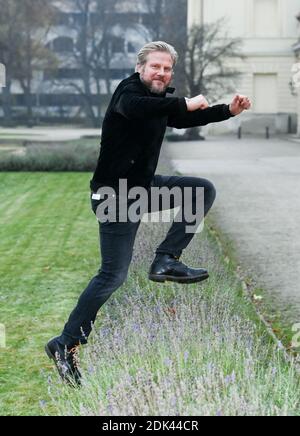 Berlin, Germany. 03rd Dec, 2020. Actor Martin Luding (49) jumps over a flower bed during a walk at Charlottenburg Palace. The native Berliner can now be seen as Jens Reichard in the ARD telenovela 'Rote Rosen' from the 18th season. He has already acted in numerous television films and stage productions such as 'Caveman'. His personal interests lie in crafts and sports activities, such as hiking and cycling in the mountains. His love for Africa led him on a safari of several weeks through the Serengeti and even to the Kilimanjaro. Credit: Jens Kalaene/dpa-Zentralbild/ZB/dpa/Alamy Live News Stock Photo