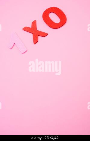 A top view of 1x0 written with wooden numbers on a pink surface Stock ...