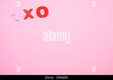 A top view of 1x0 written with wooden numbers on a pink surface Stock ...