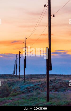 Wooden pylons with wires. Power line in rural. Stock Photo