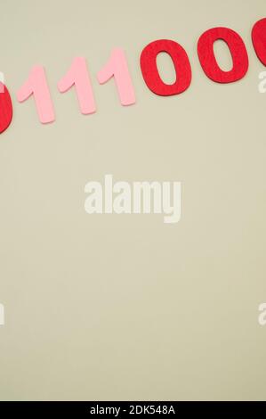 A vertical of red and pink binary codes on a white surface Stock Photo