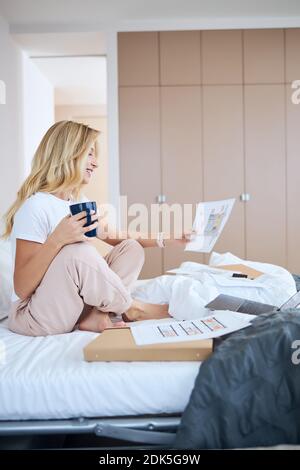 Positive delighted blonde working with great inspiration Stock Photo