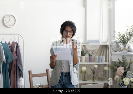 Young lady designer searching information in internet using virtual assistant Stock Photo