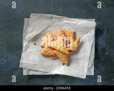 freshly baked cheese cookies on blue painted background, top view Stock Photo