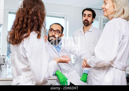 Scientists talking in laboratory Stock Photo