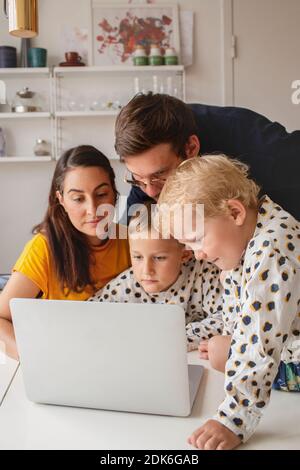 Family at home using laptop Stock Photo